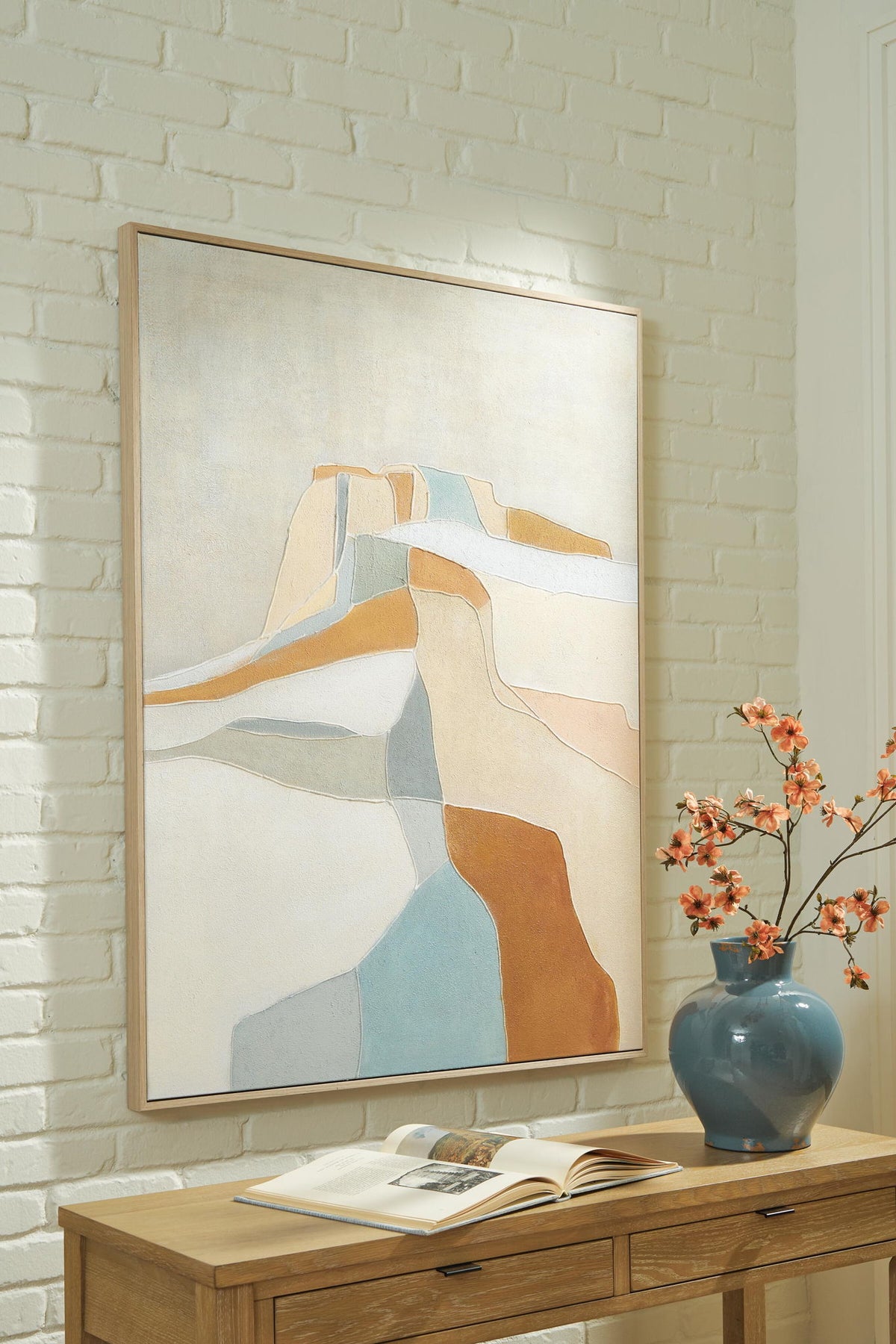 Framed abstract wall art with pastel blocks and curved lines in tan and blue