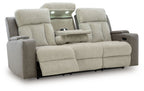 Power reclining sofa side view in light tan fabric with recline console on arm