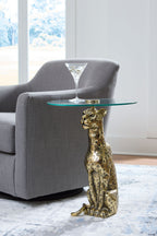 Accent table with round glass top and antique gold animal statue pedestal