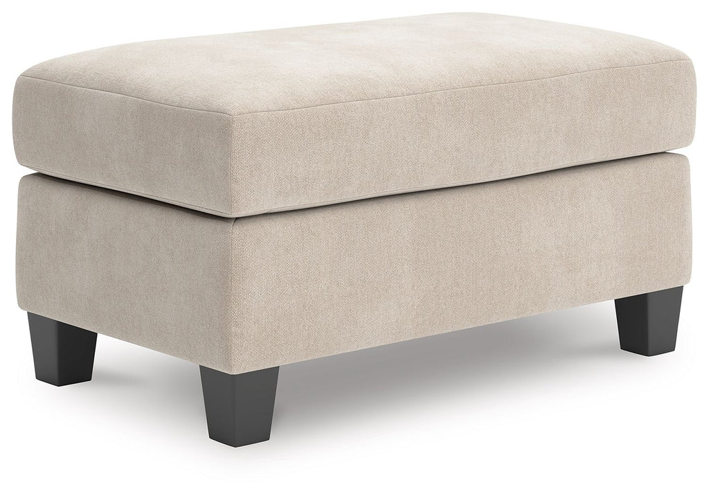 Taupe upholstered ottoman with padded seat and square top, dark wood legs