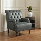 Dark gray upholstered accent chair with tufted back, rounded arms, and short wooden legs.