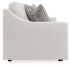 Light gray sofa with boxy arms, dark legs, and stacked gray pillows