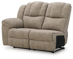Light beige reclining loveseat with dual back cushions and smooth chaise footrest