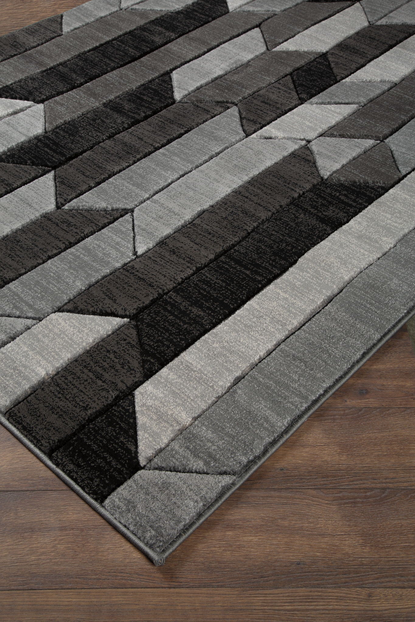 Dark gray and light gray geometric area rug with stripe and zigzag block pattern