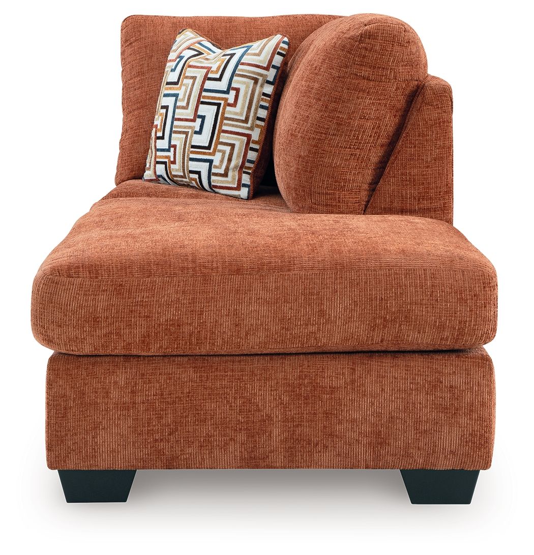 Spice orange-brown corner chaise with tall rounded back and patterned accent cushion