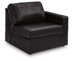 Black corner armchair with cushioned seat, rounded arms, and thick backrest