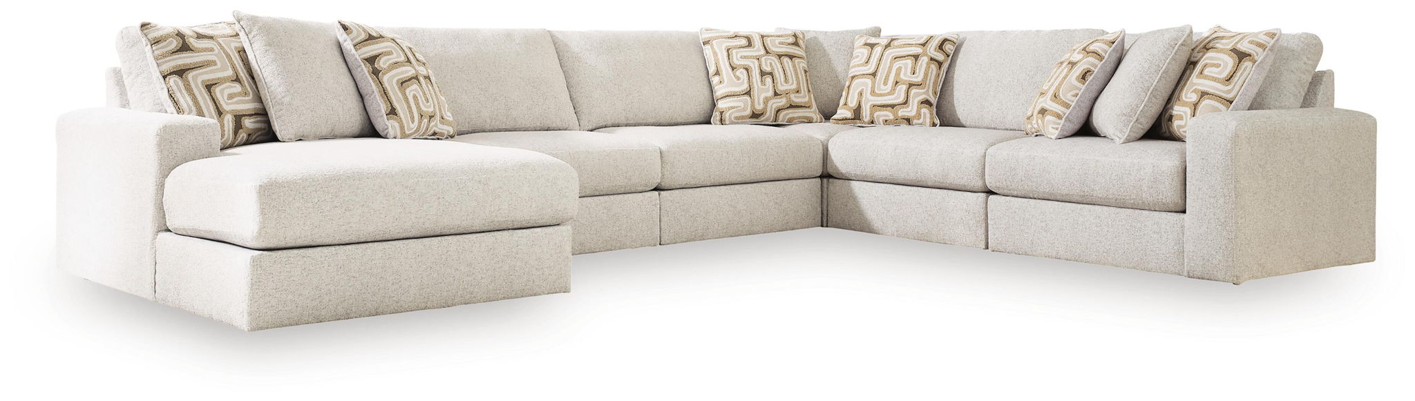 Light beige sectional sofa with two chaise-style end seats and patterned throw pillows.
