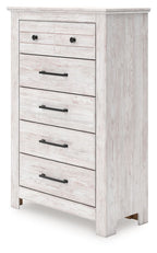 Whitewashed five-drawer chest with black bar and knob pulls