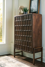 Brown accent cabinet with paneled door and open display shelf, angled view