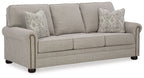 Queen sofa sleeper with light gray upholstery, three seat cushions, and two patterned pillows