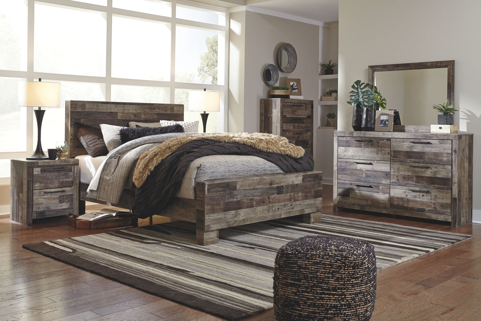 Dark gray dresser with mirror and drawers, shown in a bedroom setting