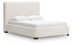 Beige upholstered bed with tall padded headboard and low block legs