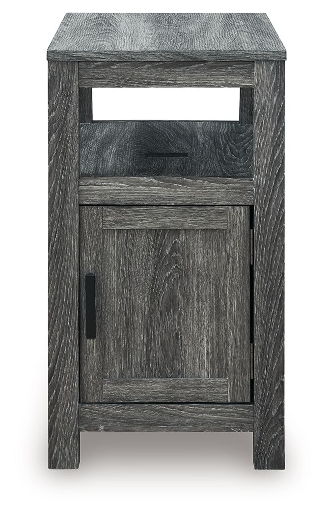 Chair side end table with open shelf and one-door cabinet, dark gray wood grain, black pull.