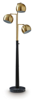Gold metal floor lamp with three round shades on a black pole and base