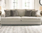 Soletren stationary sofa, light stone seating with multiple gray and patterned pillows