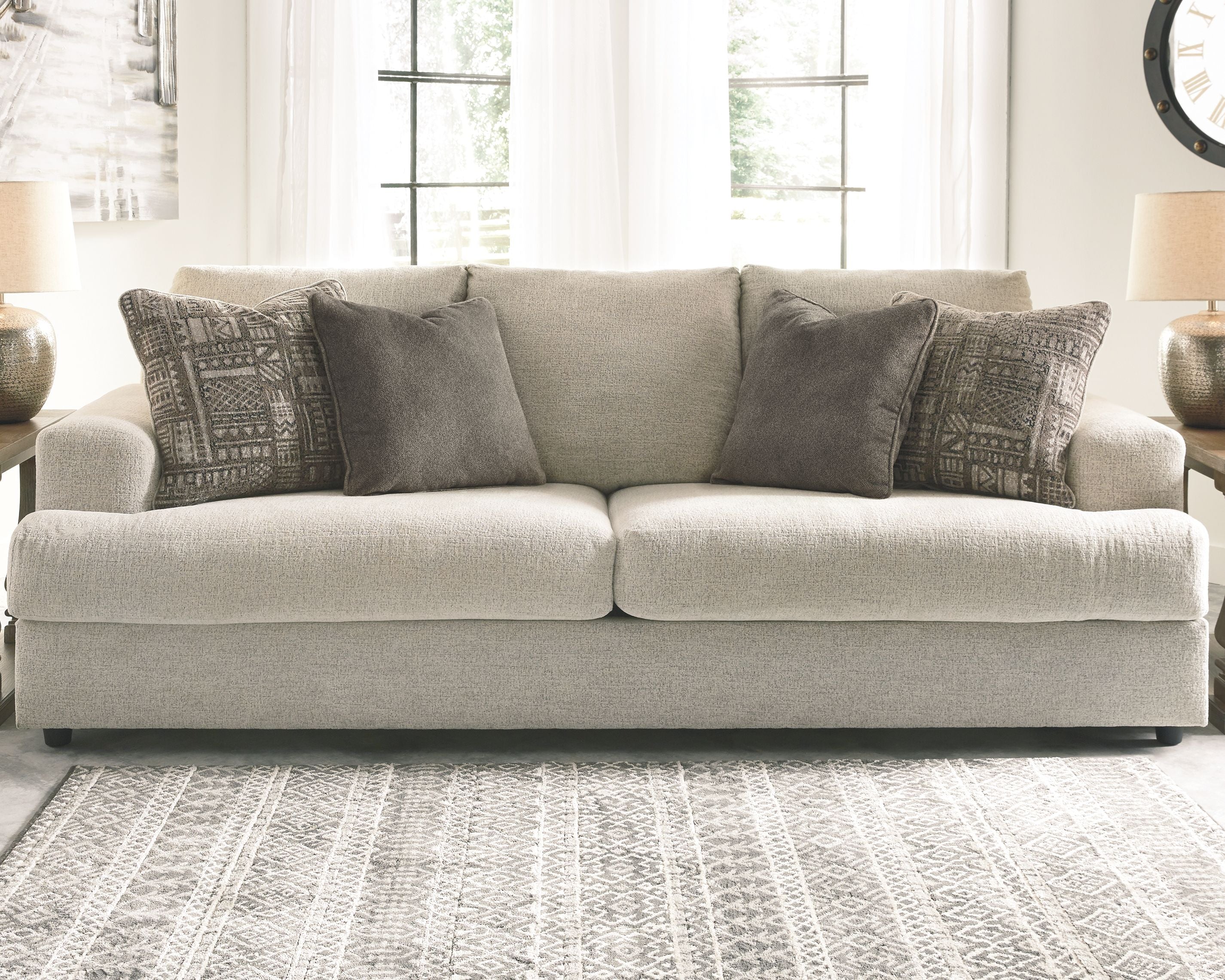 Soletren stationary sofa, light stone seating with multiple gray and patterned pillows