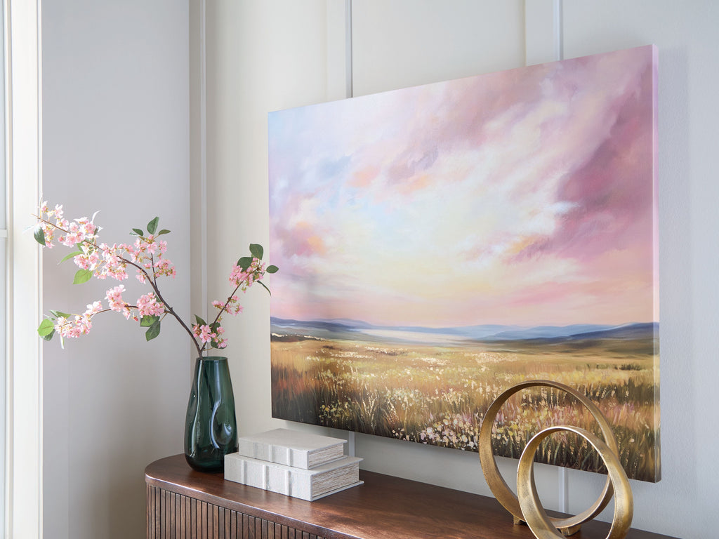 Landscape wall art on wall with pastel sky over golden meadow and hills