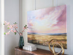 Landscape wall art on wall with pastel sky over golden meadow and hills