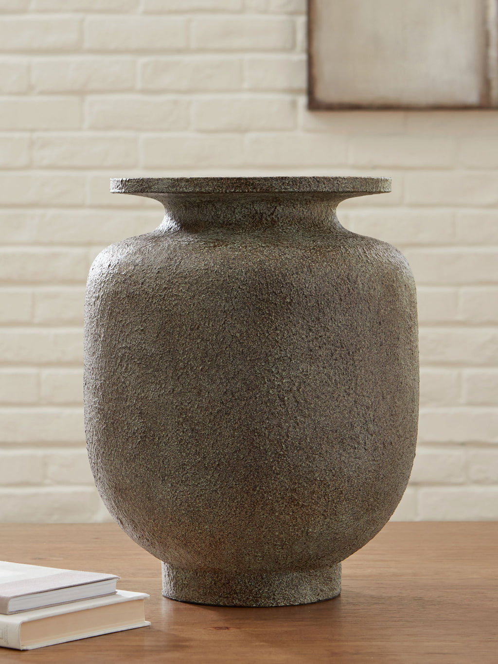 Gray stone-look vase with flared neck on tabletop