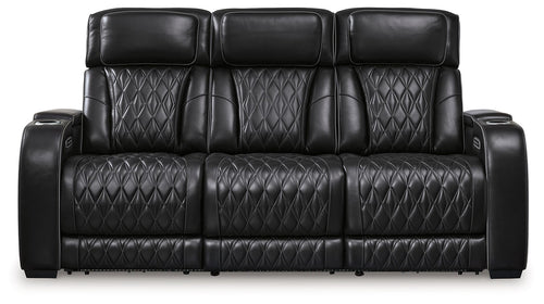 Black power reclining sofa with three padded headrests and diamond-quilted upholstery