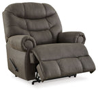 Gunmetal recliner with plush back, padded headrest, and side recline mechanism.