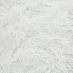 White shaggy faux fur upholstery texture on an oversized rounded ottoman