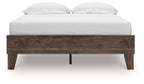 Platform bed with light brown wood headboard and two white pillows