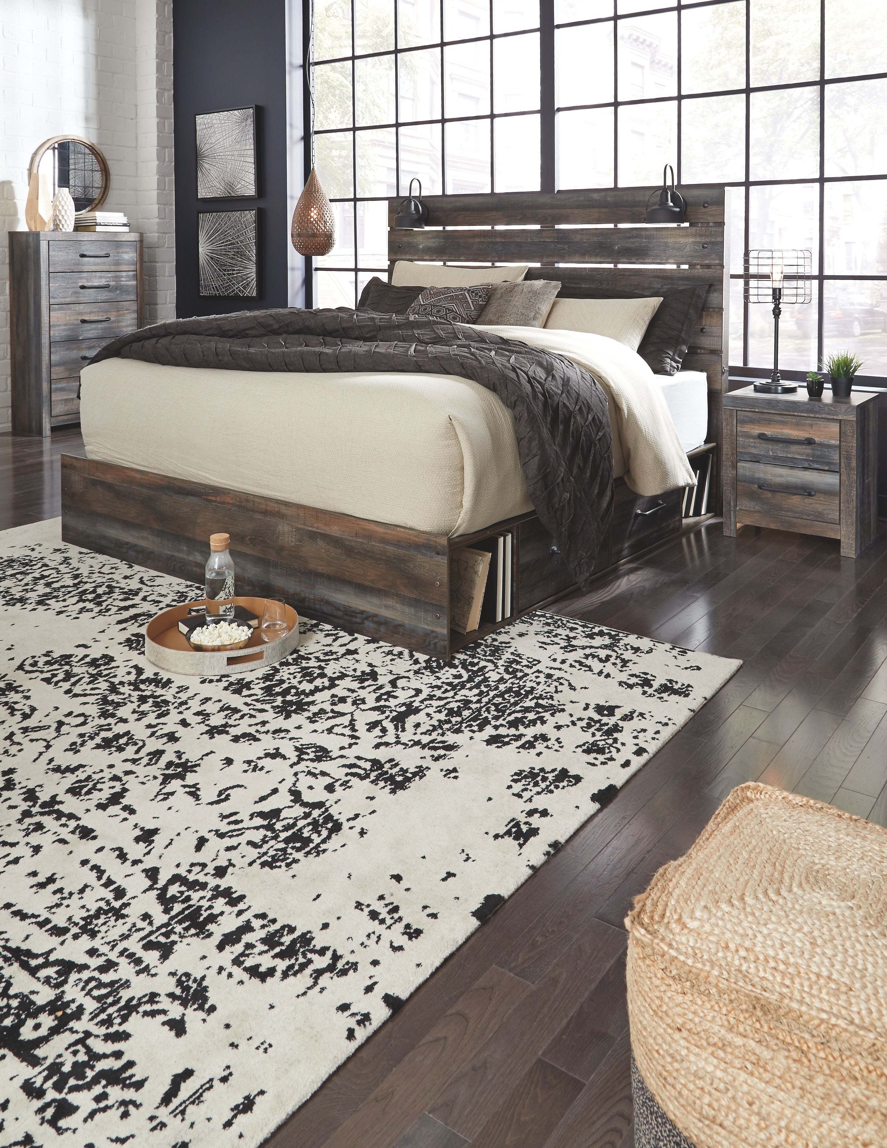 Dark wood panel bed with slatted headboard and drawers, with matching bedside tables