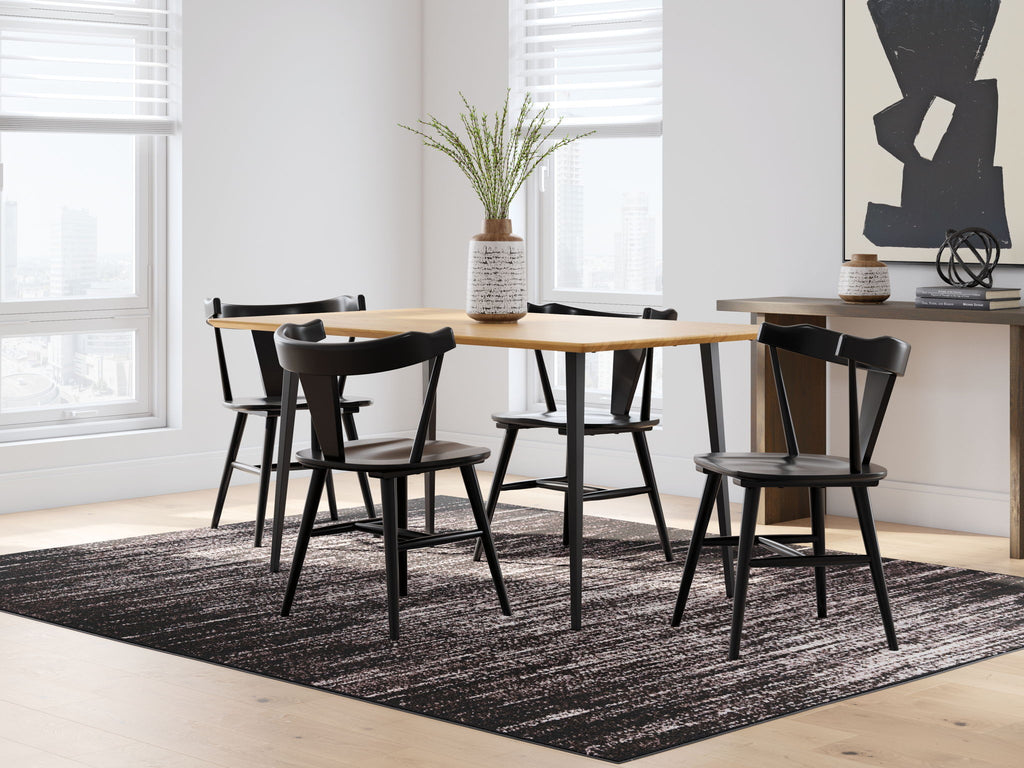 Light brown dining table with four black chairs and matching legs