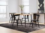 Light brown dining table with four black chairs and matching legs