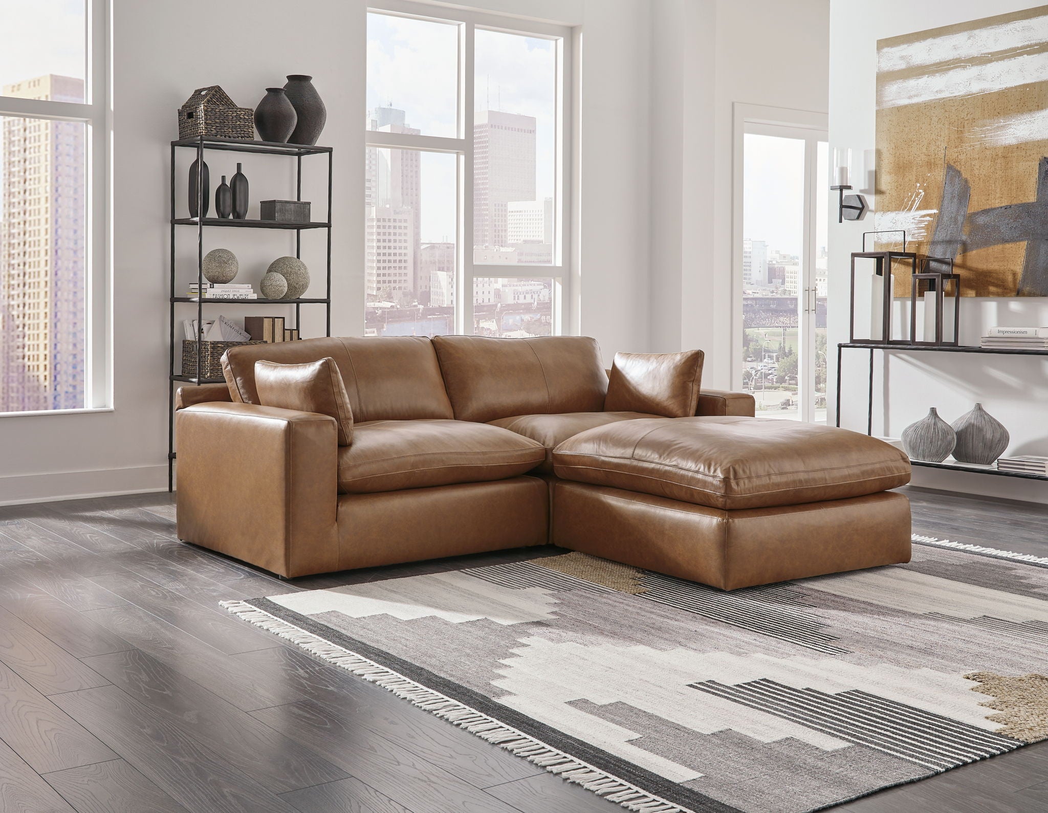 Caramel-brown corner sectional loveseat with chaise and decorative pillows