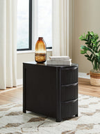 Black chair side end table with ribbed drawer fronts and open storage shelf
