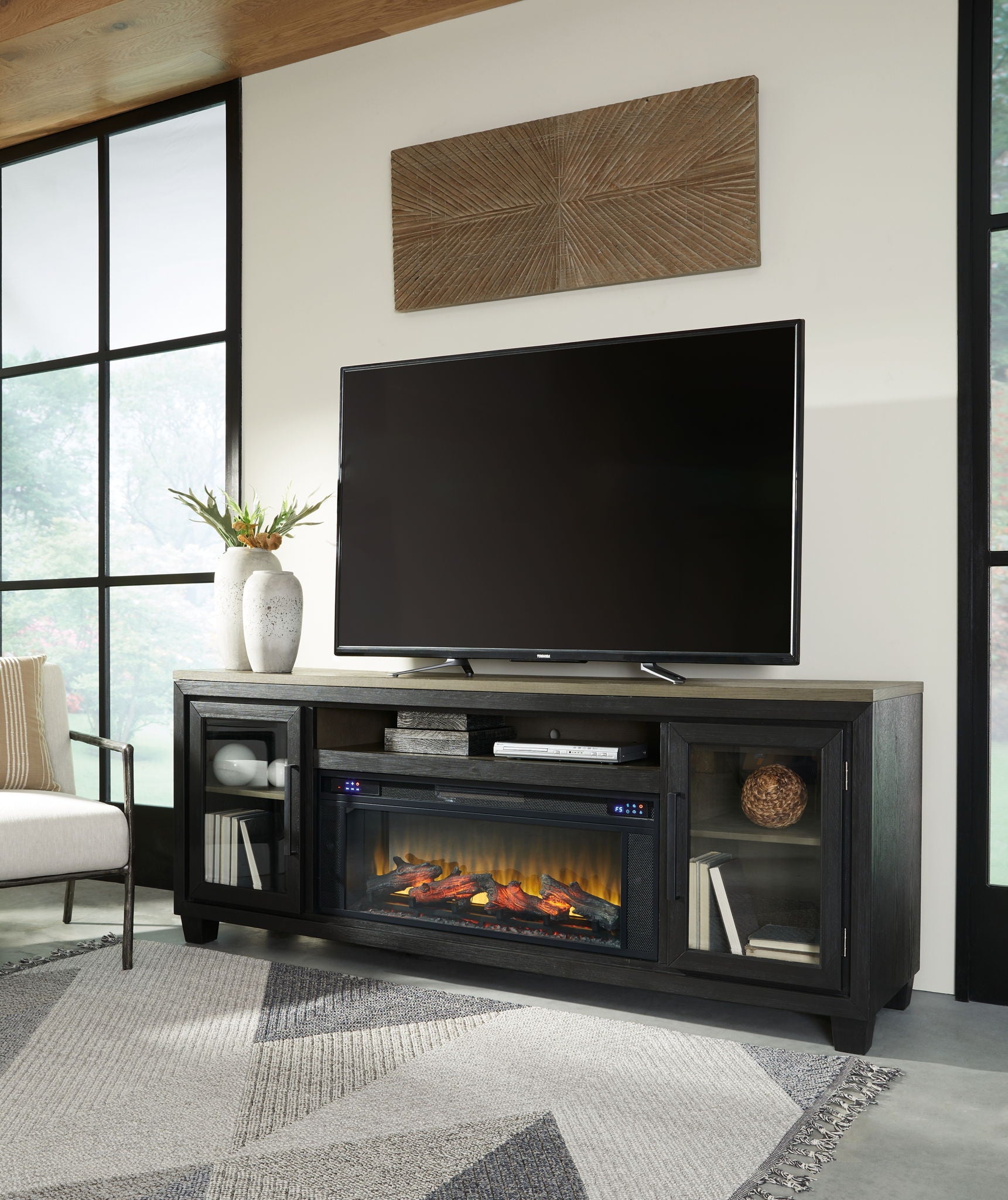 Black TV stand with electric fireplace insert, TV on top, side cabinets and open shelves