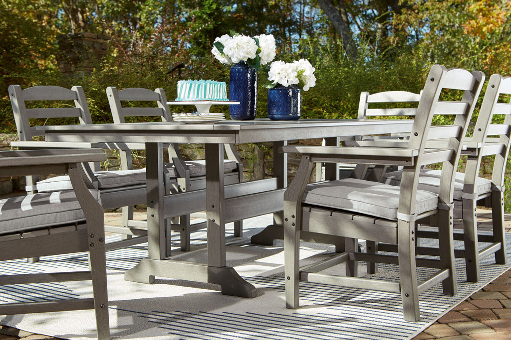 Gray outdoor dining table with six matching slat-back chairs