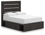 Dark gray panel storage bed with drawer front and white upholstered mattress