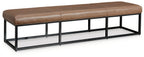 Caramel brown bench cushion on black metal frame with open lower shelf