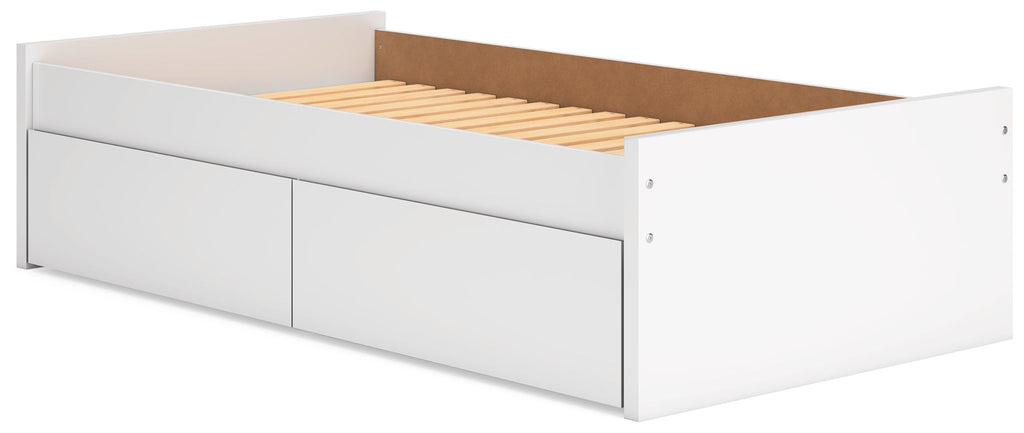 White platform bed with pull-out drawer fronts and exposed slat mattress base