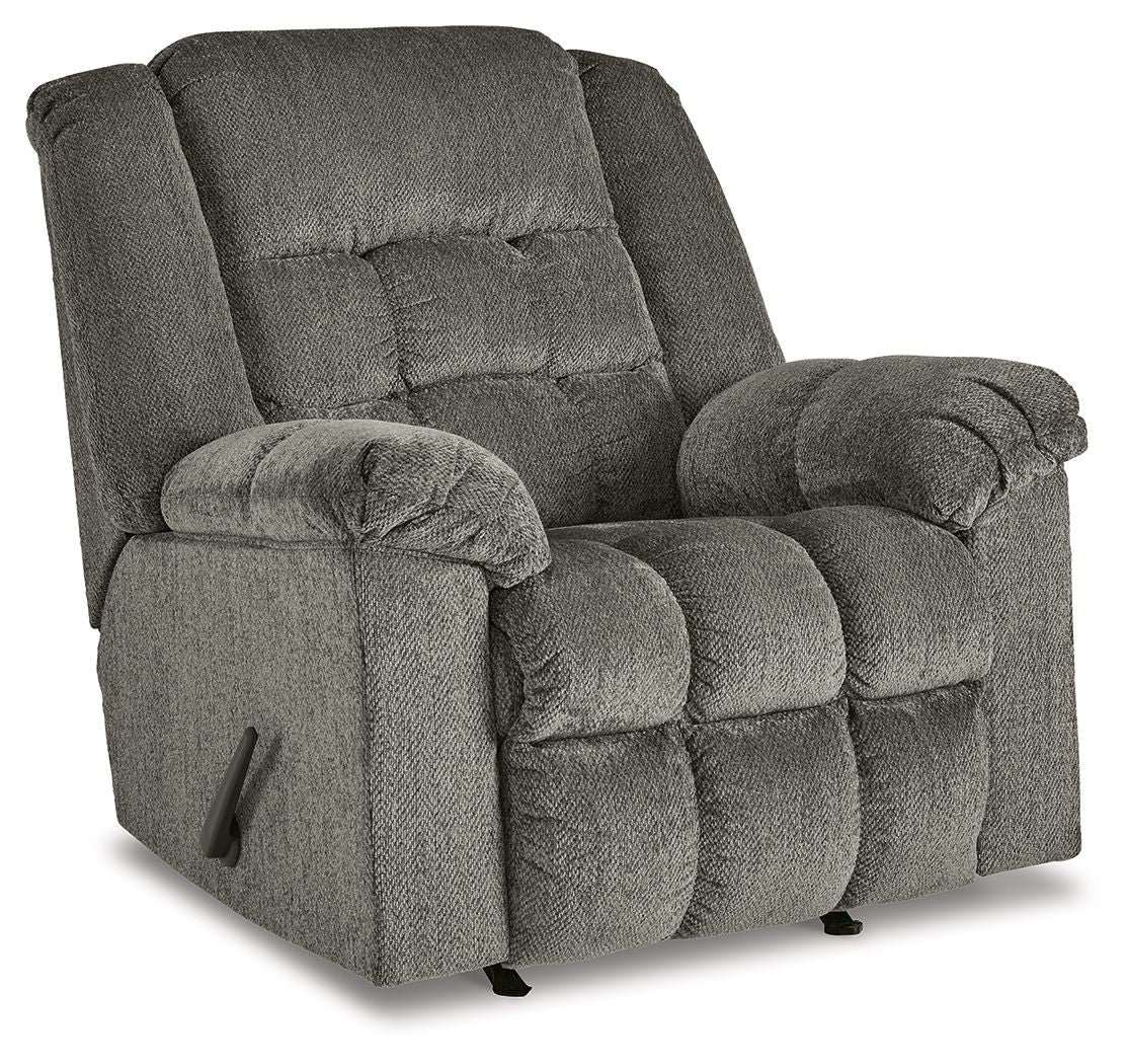 Gray rocker recliner chair with tufted back, padded arms, side control handle