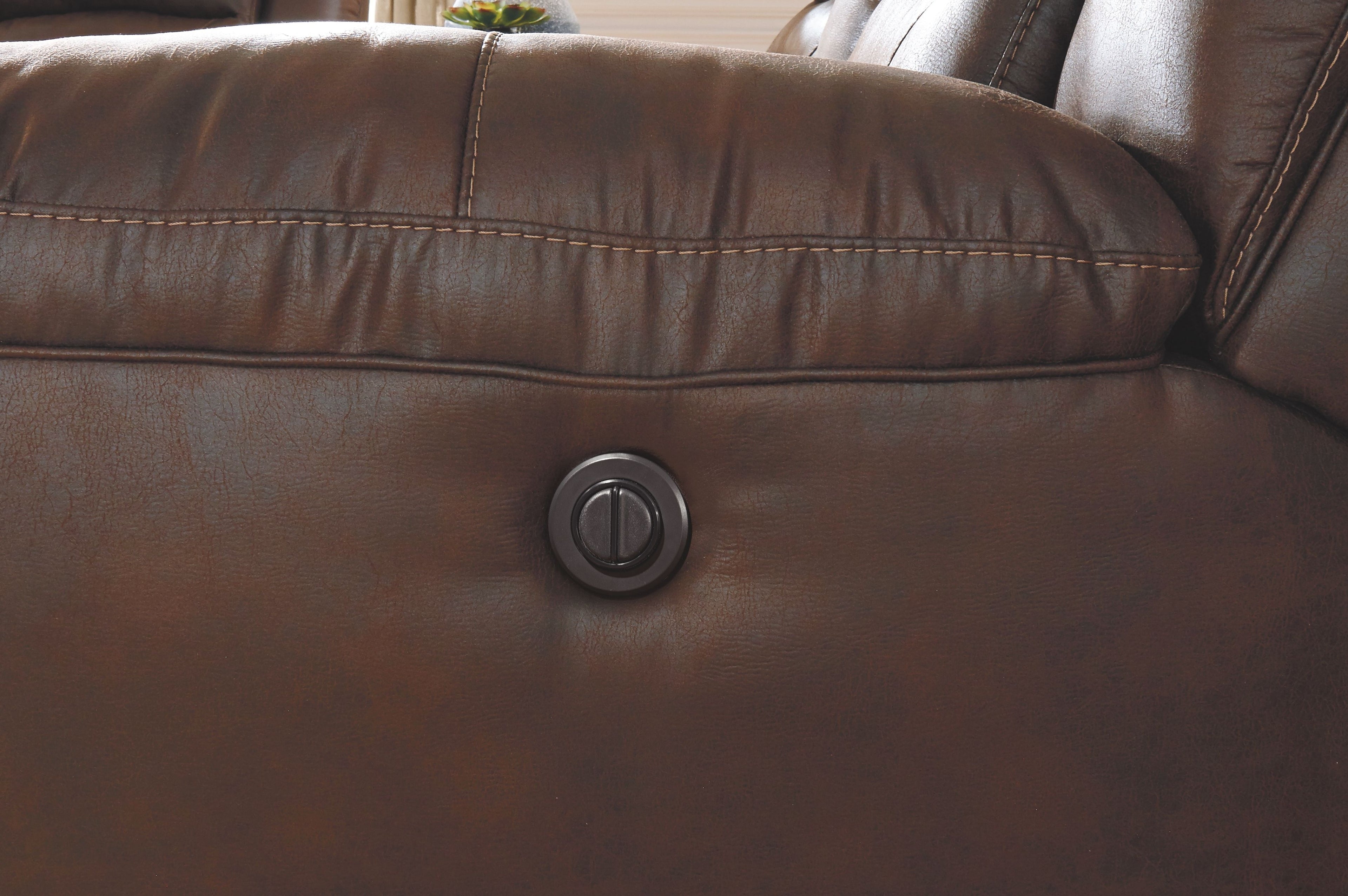 Dark brown power recliner back with a round control knob