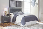 Gray upholstered panel headboard with button-tufted details and nailhead trim