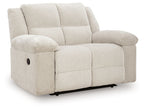 Recliner chair in light beige, side view, extended footrest and rounded arm pads