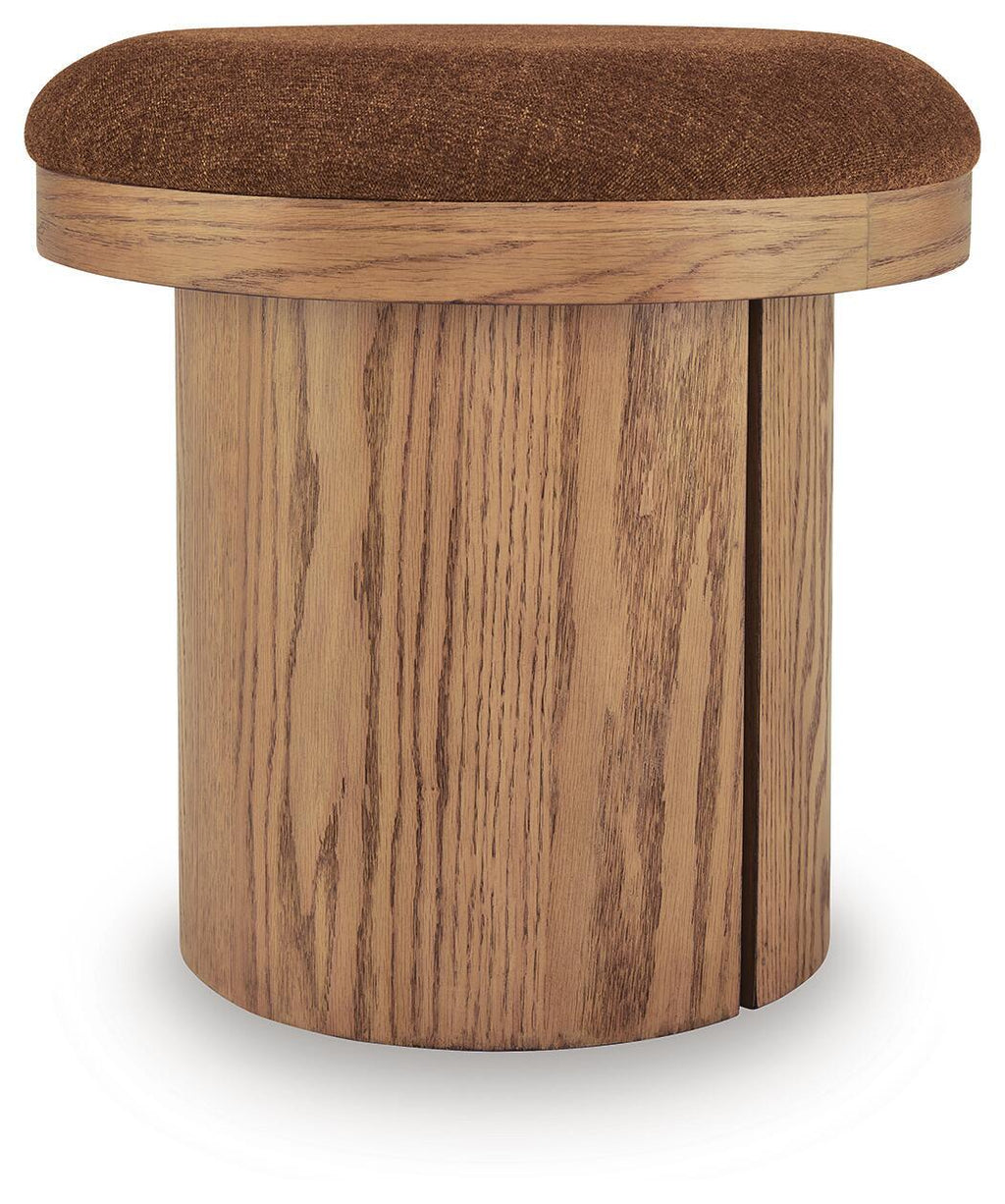 Round accent ottoman with brown fabric top and light wood cylindrical base