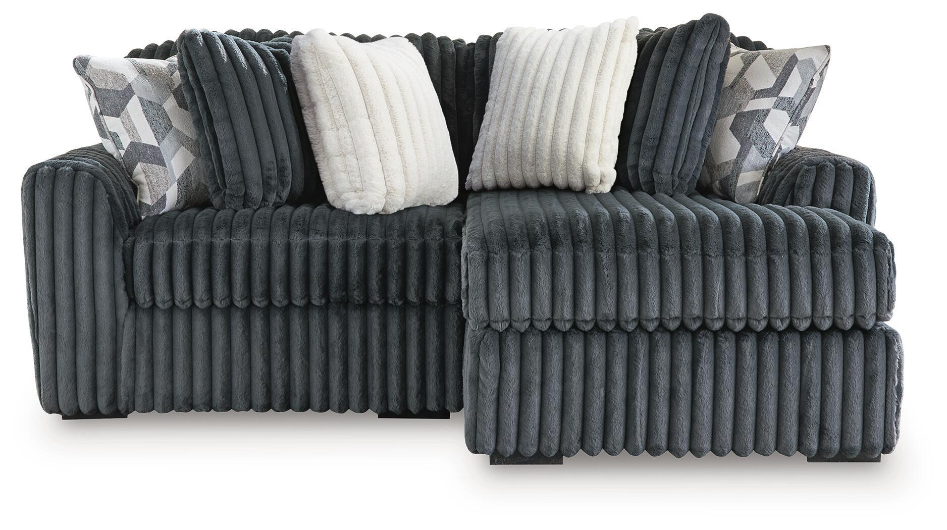 Dark charcoal corduroy sectional sofa with corner chaise and white accent pillows
