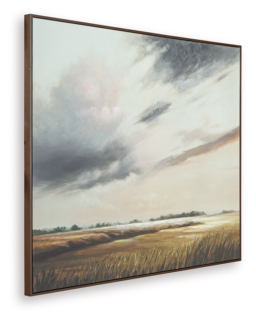 Framed landscape wall art with cloudy sky over distant fields