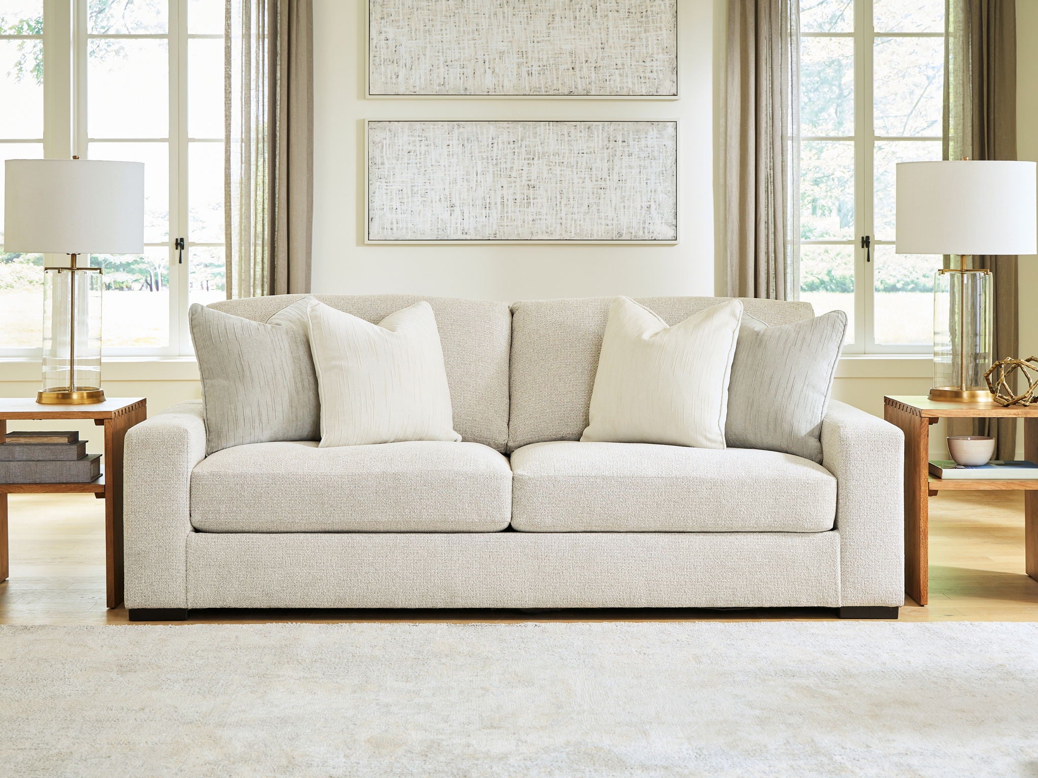 Conlee-Pike linen sofa in light beige with multiple throw pillows and black legs