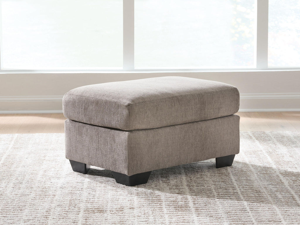 Light gray fabric ottoman with upholstered top and dark block feet