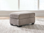 Light gray fabric ottoman with upholstered top and dark block feet