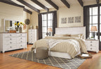 Willowton bedroom set with panel headboard bed, dresser, mirror, and nightstands