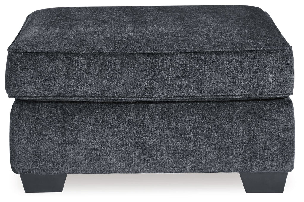 Dark gray upholstered accent ottoman with padded lid and visible front panel seams
