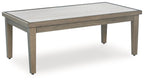 Rectangular cocktail table with light gray-beige tabletop and brown wood base